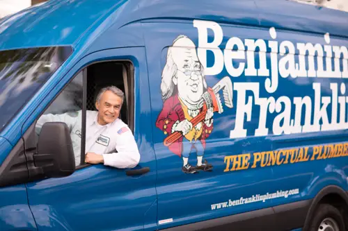 Benjamin Franklin Plumbing Tech, Mike, smiling while hanging out his drivers side window