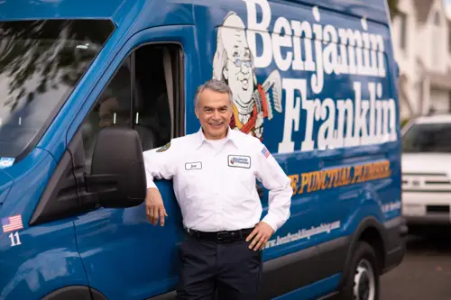 Benjamin Franklin Plumbing, Mike, standing outside his van at a home in Miami