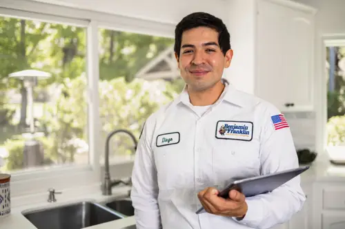 Closeup of Benjamin Franklin Plumbing Tech, Diego at a kitchen in a Miami FL home